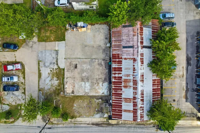 an aerial view of residential houses with outdoor space and swimming pool