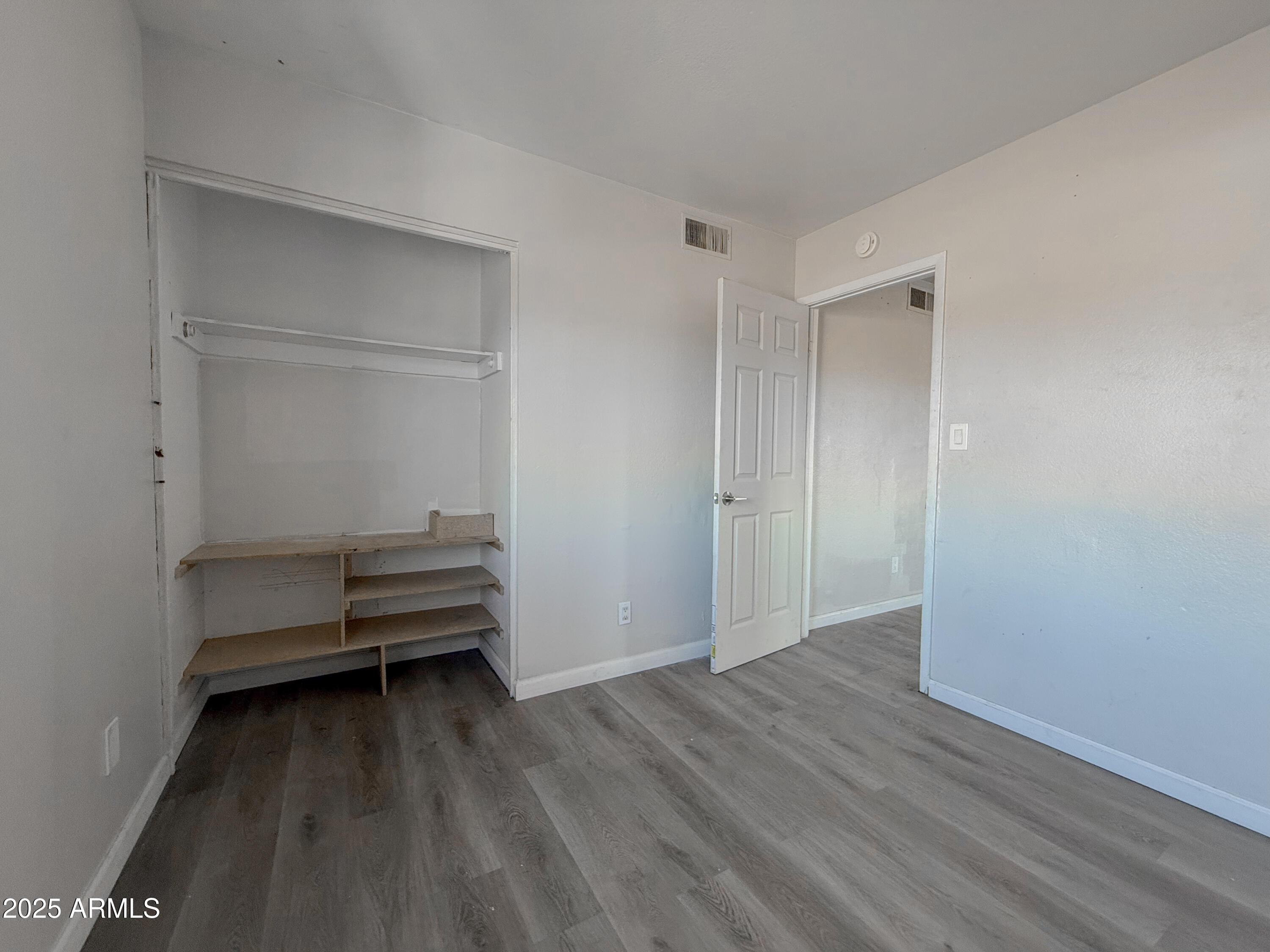 1703 West Mountain View Road, Unit 13 Phoenix, AZ 85021 - Photo 12 of 12 a view of a room with wooden floor and white walls