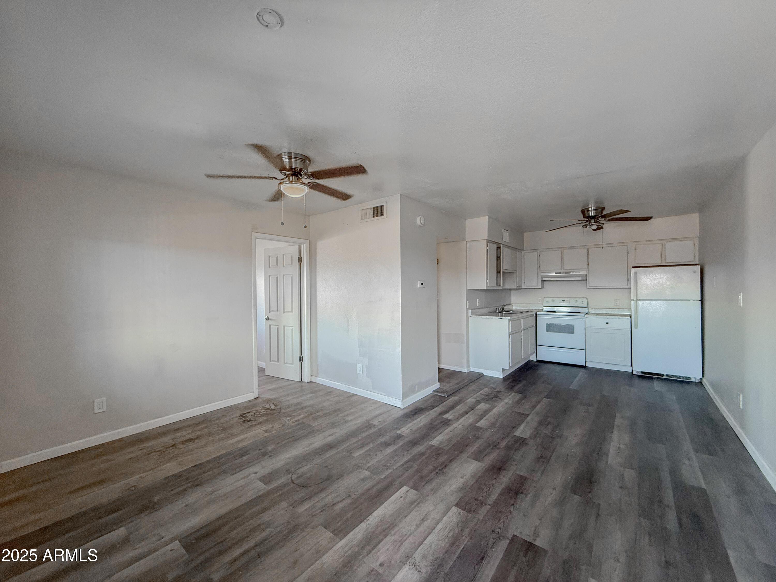 1703 West Mountain View Road, Unit 13 Phoenix, AZ 85021 - Photo 4 of 12 a view of a kitchen with a sink and a refrigerator