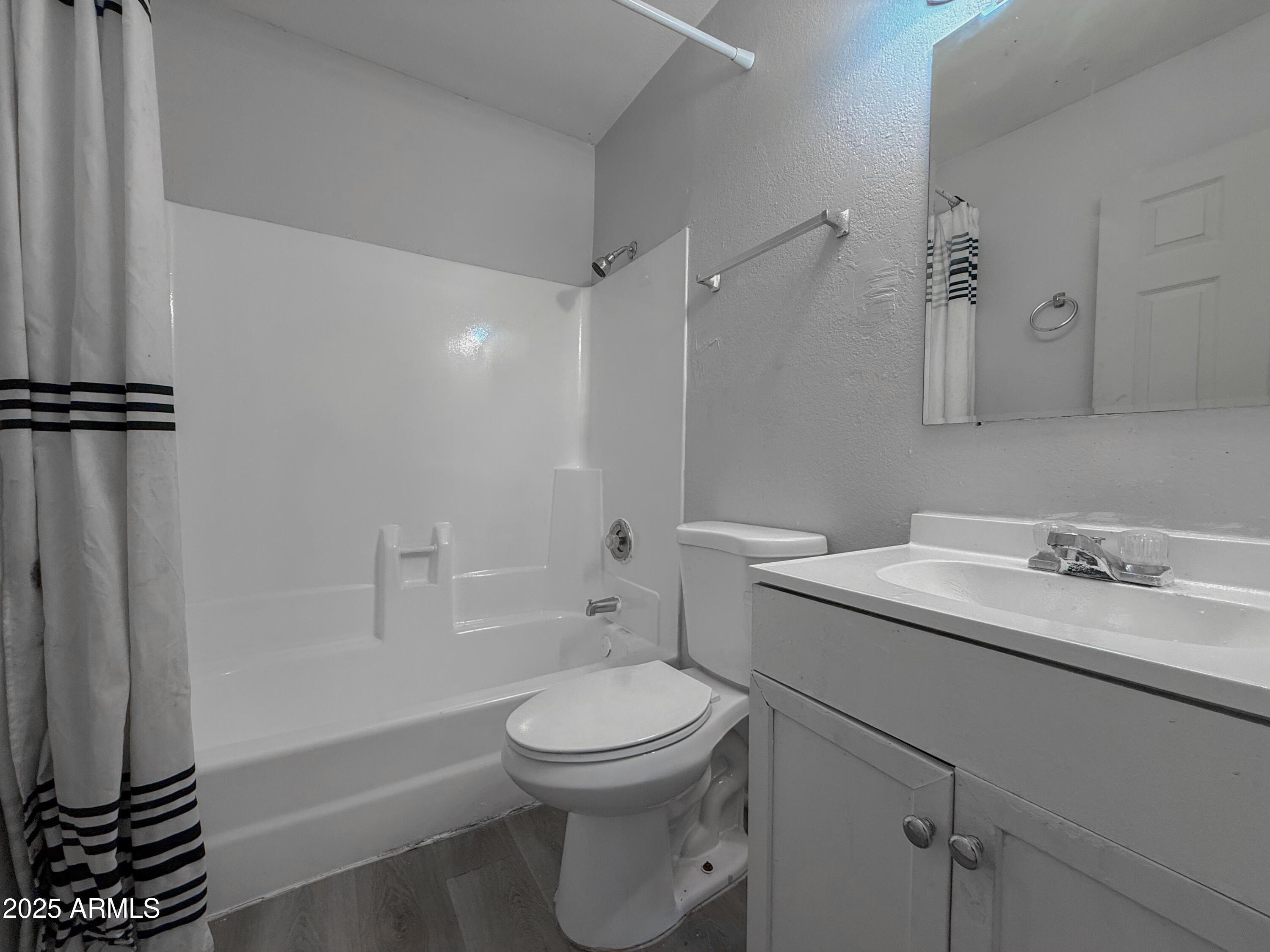 1703 West Mountain View Road, Unit 13 Phoenix, AZ 85021 - Photo 5 of 12 a bathroom with a sink a toilet and shower