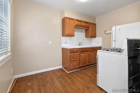 a kitchen with a stove a refrigerator and a microwave