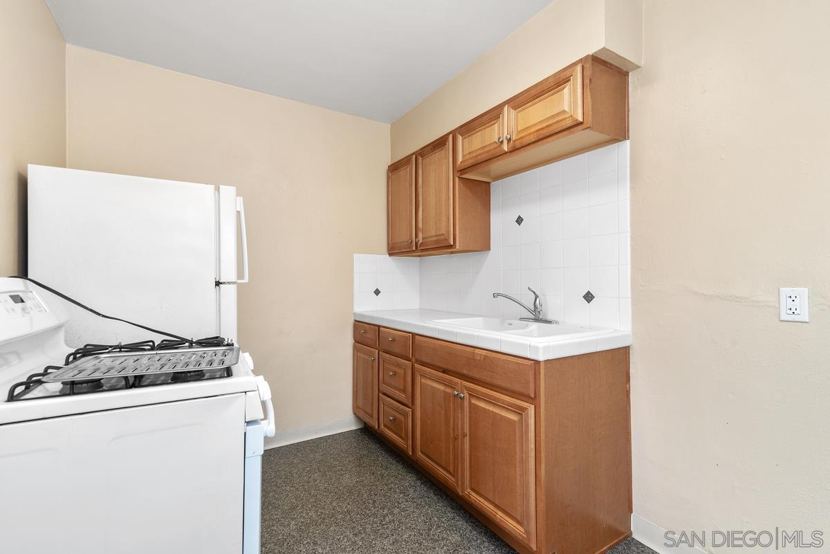 3378 B Street San Diego, CA 92102 - Photo 7 of 27 a utility room with cabinets washer and dryer