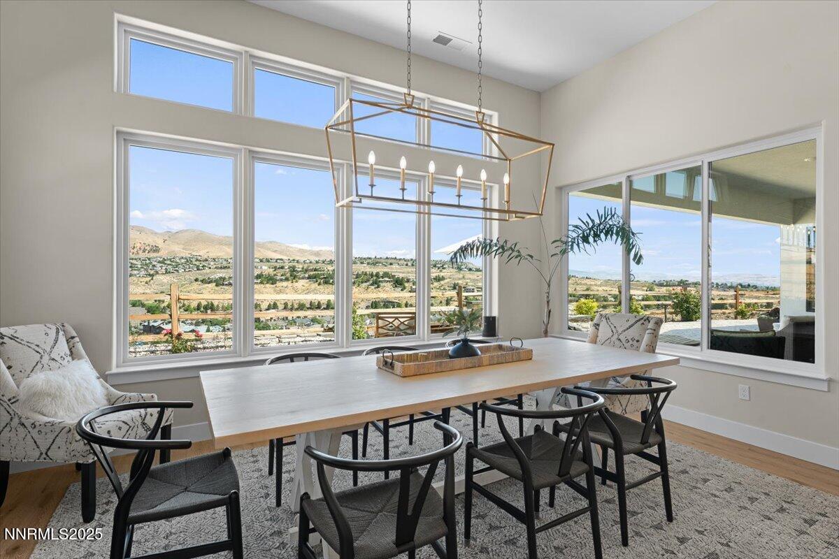 1593 River Hill Way Reno, NV 89523 - Photo 12 of 63 a dining room with furniture a chandelier and wooden floor