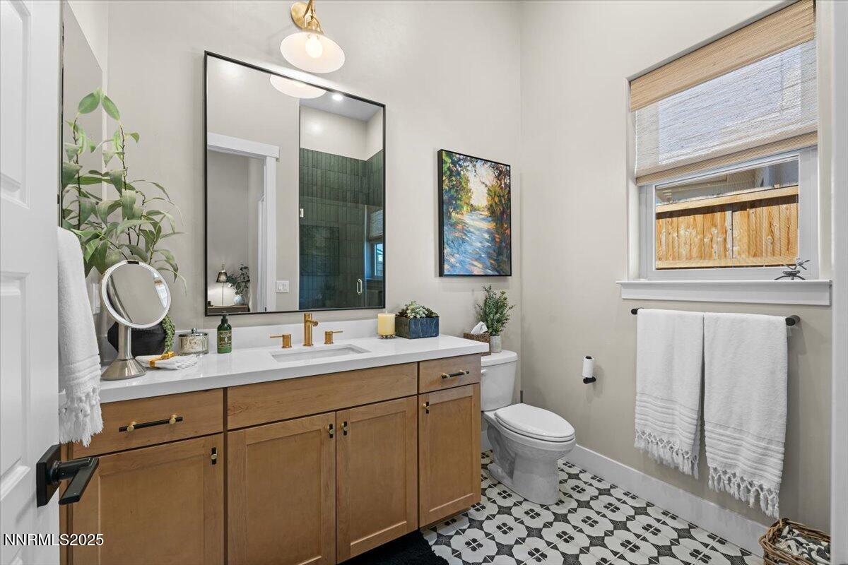 1593 River Hill Way Reno, NV 89523 - Photo 26 of 63 a bathroom with a sink a toilet and a mirror