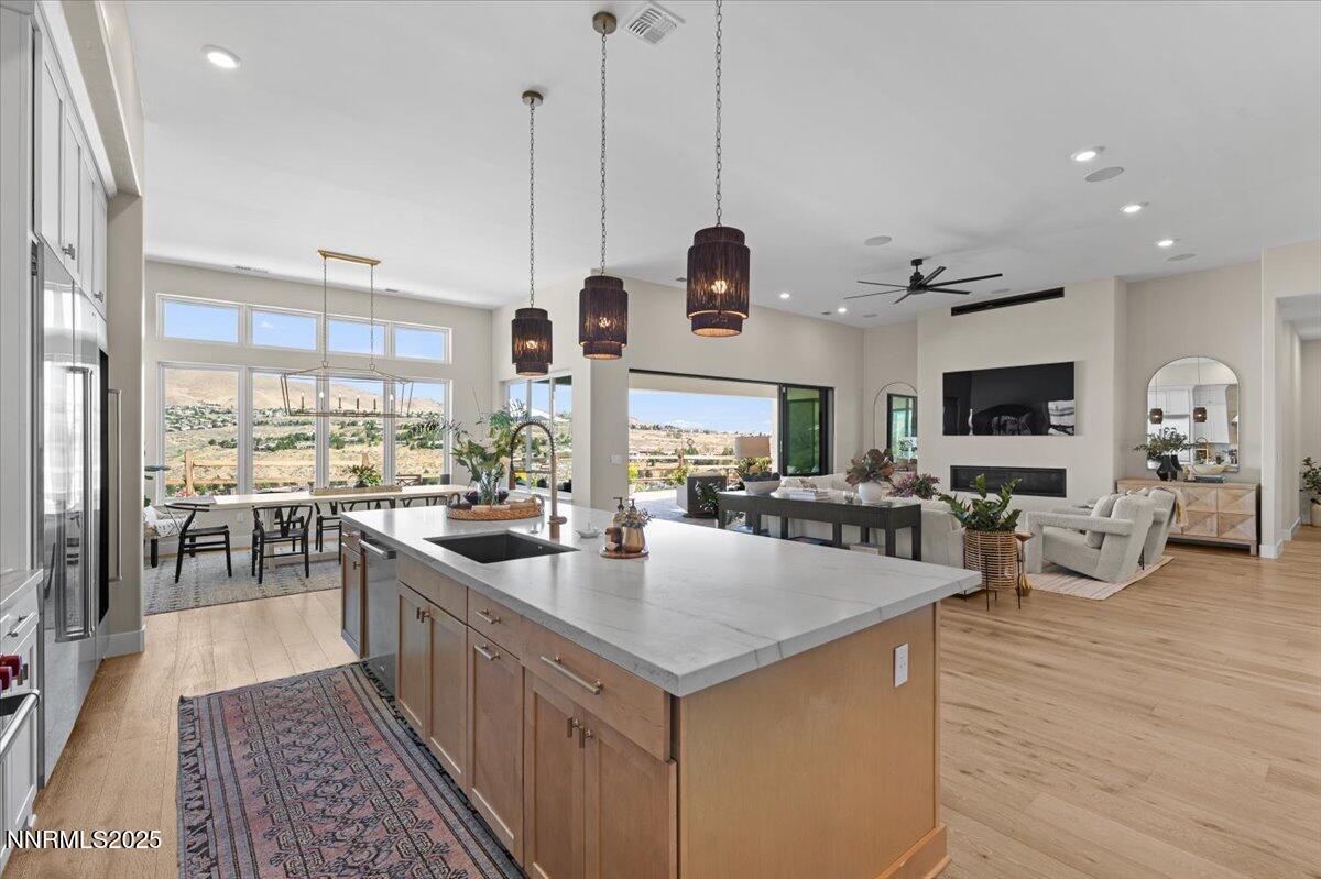 1593 River Hill Way Reno, NV 89523 - Photo 10 of 63 a kitchen with stainless steel appliances granite countertop a sink and a wooden floors