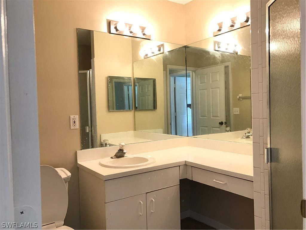 4458 28th Street Southwest Lehigh Acres, FL 33973 - Photo 13 of 22 a bathroom with a sink and a mirror