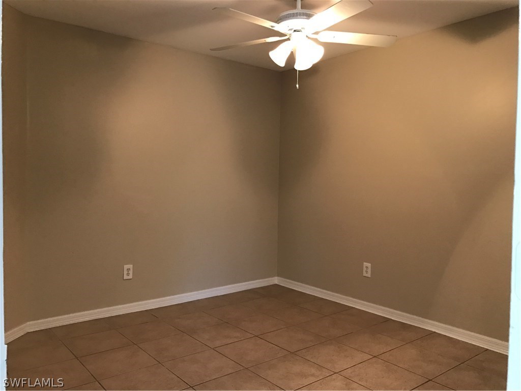 4458 28th Street Southwest Lehigh Acres, FL 33973 - Photo 15 of 22 en empty room with wooden floor and fan
