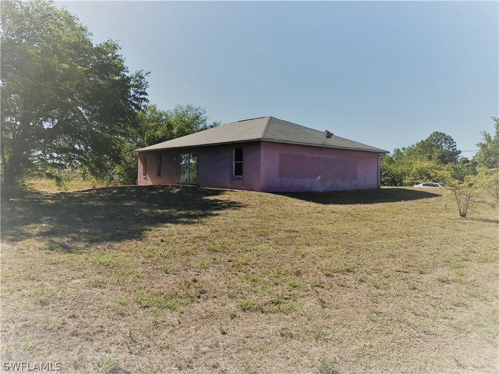 4458 28th Street Southwest Lehigh Acres, FL 33973 - Photo 3 of 22 a view of a house with a yard