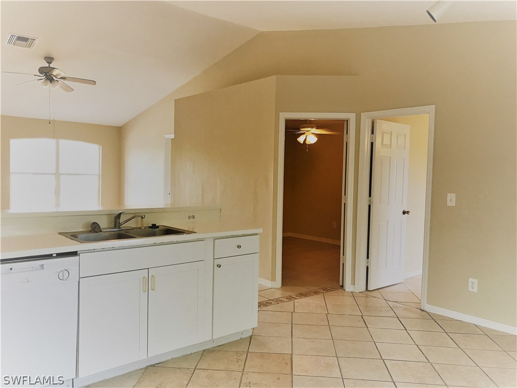 4458 28th Street Southwest Lehigh Acres, FL 33973 - Photo 10 of 22 a bathroom with a granite countertop sink and a mirror