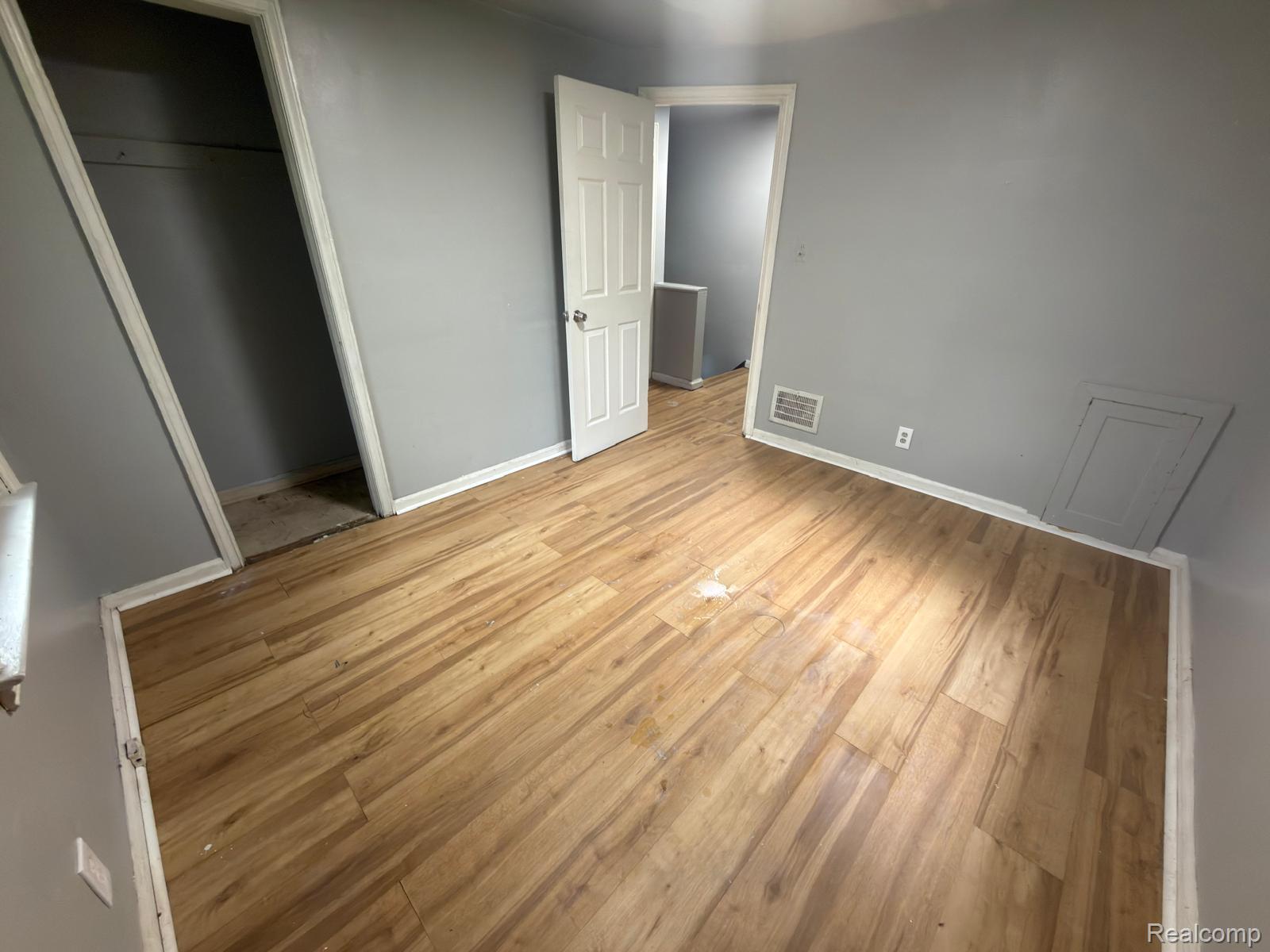 8837 Evergreen Road Detroit, MI 48228 - Photo 13 of 16 Room featuring wood-finish flooring, light gray wall paint, and white baseboards