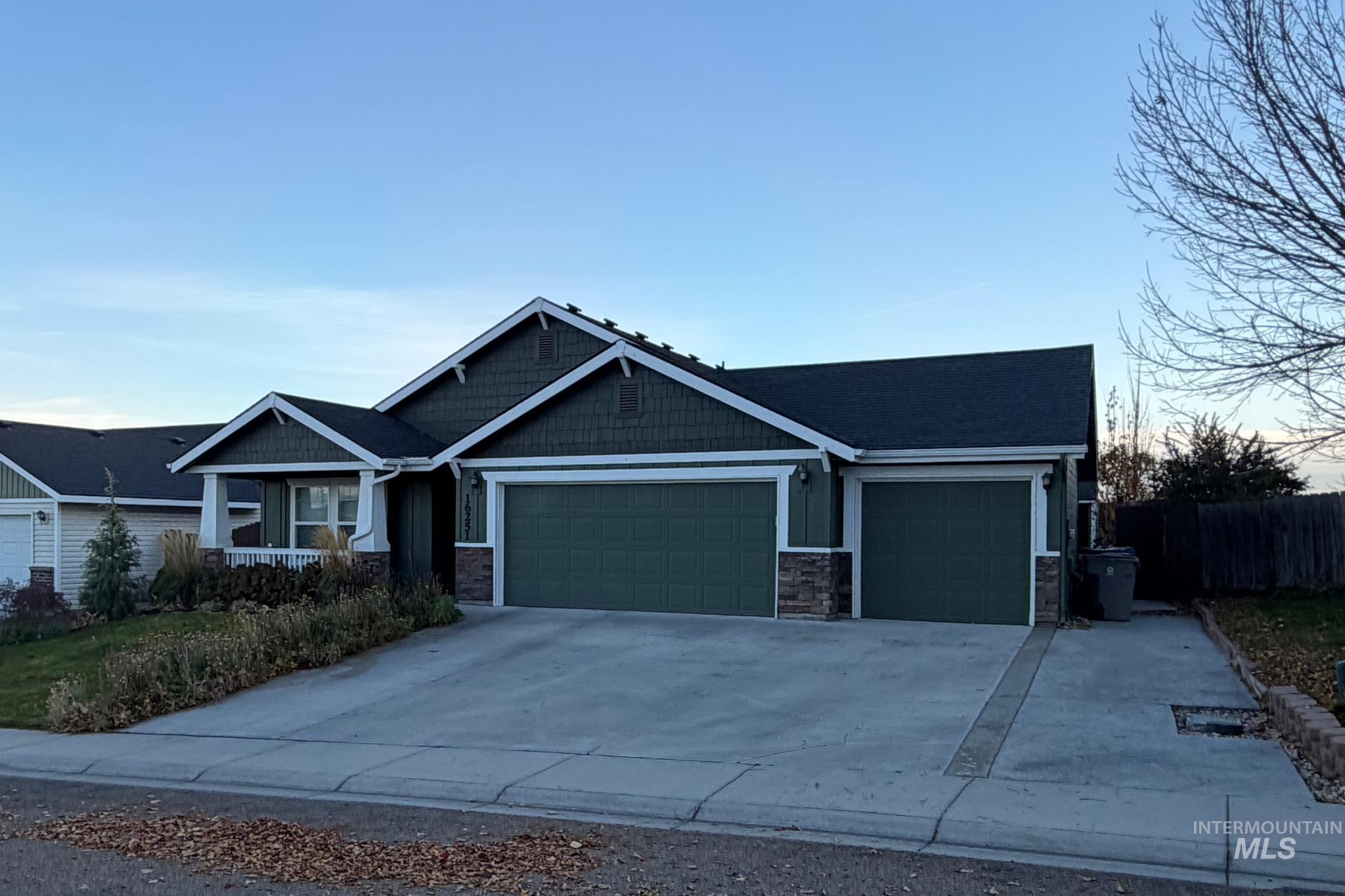 16251 Copperridge Way Caldwell, ID 83607 - Photo 1 of 3 Craftsman-style house featuring stone siding, driveway, and a garage