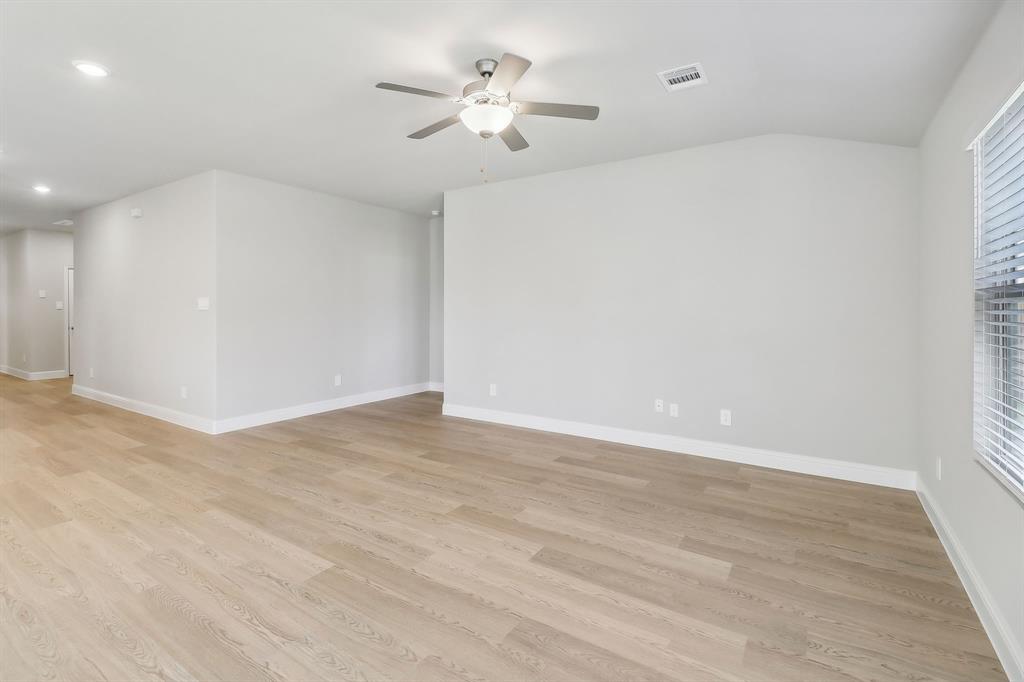 905 Buffalo Drive Lowry Crossing, TX 75407 - Photo 11 of 28 a view of a room with a ceiling fan and wooden floor