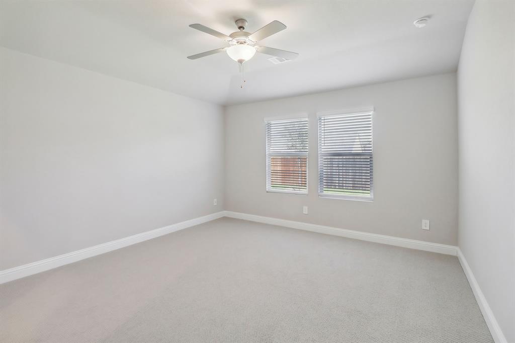905 Buffalo Drive Lowry Crossing, TX 75407 - Photo 21 of 28 an empty room with windows and ceiling fan