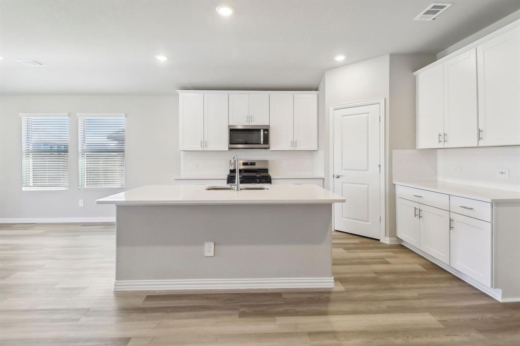 905 Buffalo Drive Lowry Crossing, TX 75407 - Photo 4 of 28 a kitchen with white cabinets and window