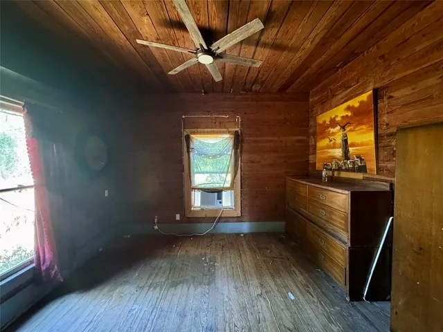 a kitchen with granite countertop a stove a sink and wooden cabinets