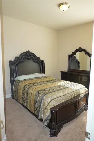 a bedroom with a bed and a lamp