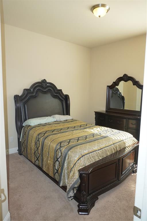 15608 Cornwallis Street Frisco, TX 75036 - Photo 14 of 23 a bedroom with a bed and a lamp