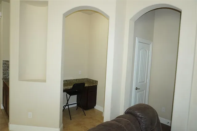 a living room with a chair and a table