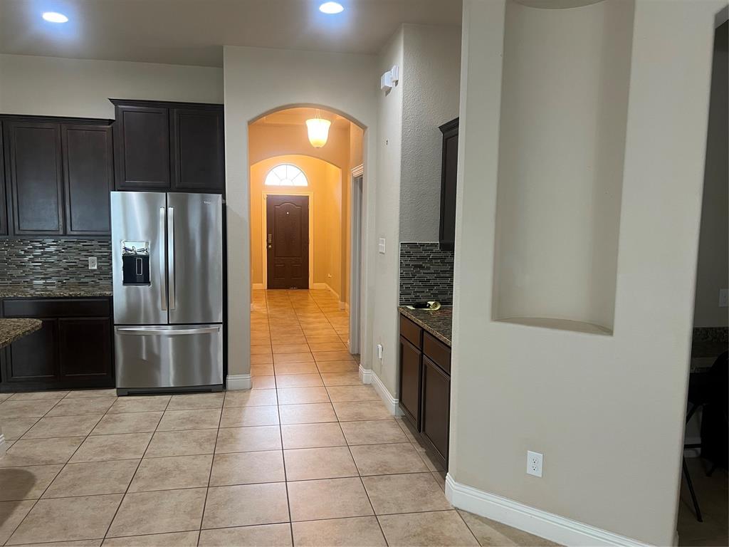 15608 Cornwallis Street Frisco, TX 75036 - Photo 6 of 23 a kitchen with stainless steel appliances granite countertop a refrigerator and a sink