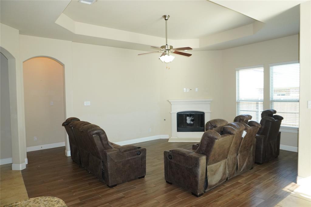 15608 Cornwallis Street Frisco, TX 75036 - Photo 7 of 23 a living room with furniture and a fireplace