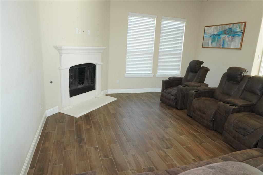 15608 Cornwallis Street Frisco, TX 75036 - Photo 10 of 23 a living room with furniture and a fireplace