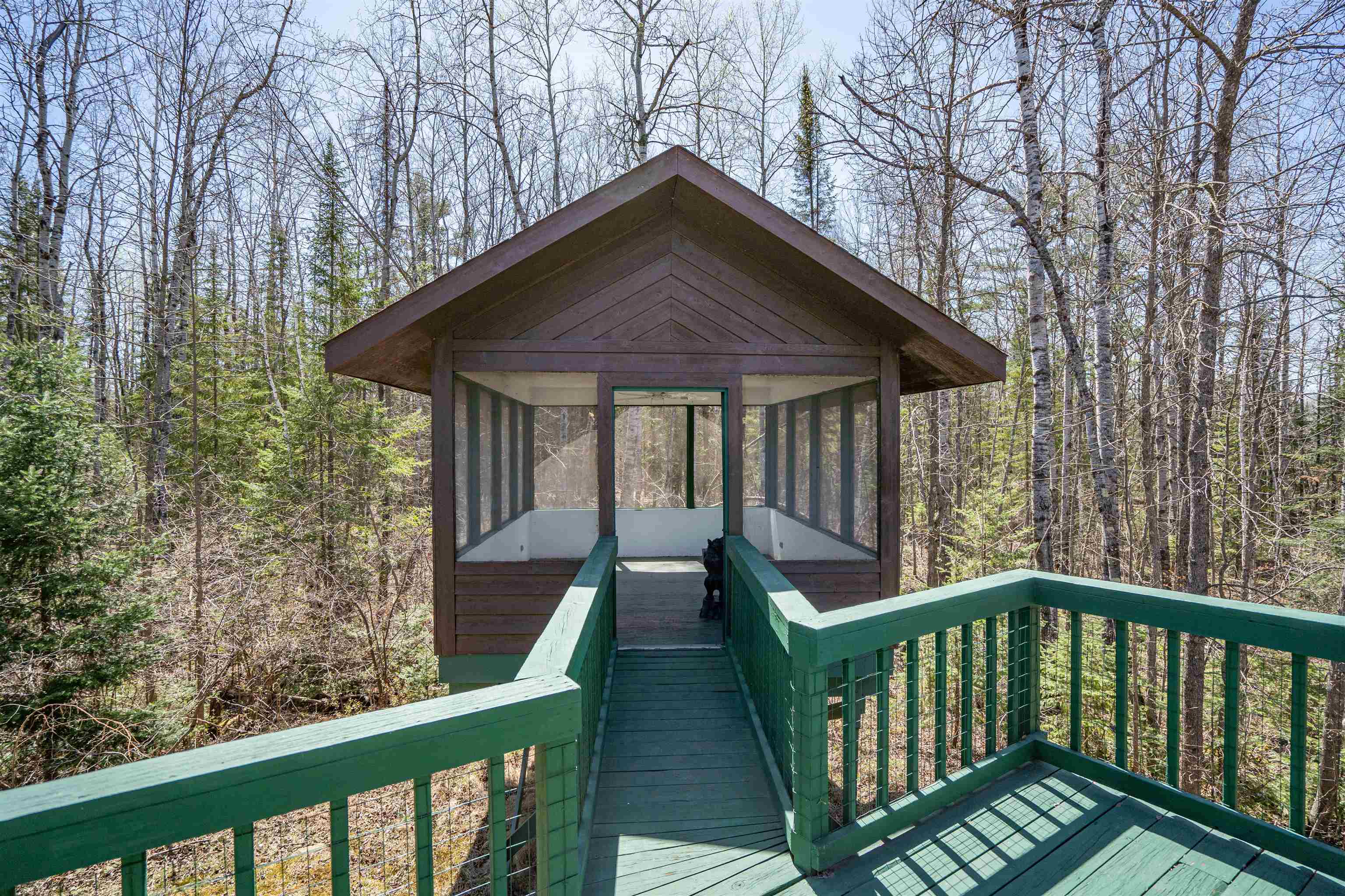 6960 South County Rd B Foxboro, WI 54836 - Photo 17 of 28 Wooden terrace featuring a sunroom and a forest view