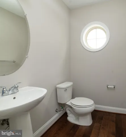 a white toilet sitting next to a bathroom sink