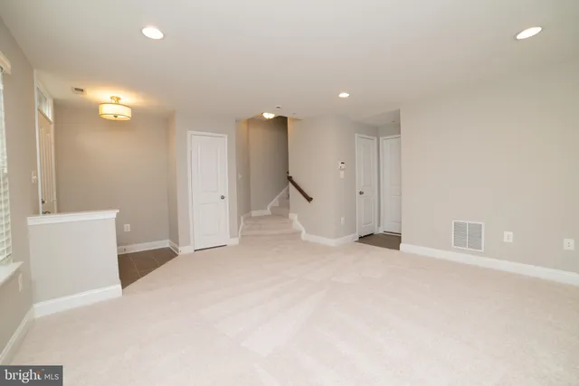 an empty room with a bathroom and a shower