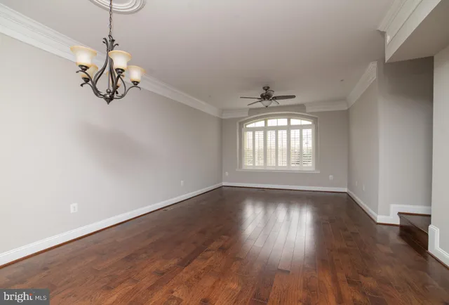 a view of a room with wooden floor cabinets and windows