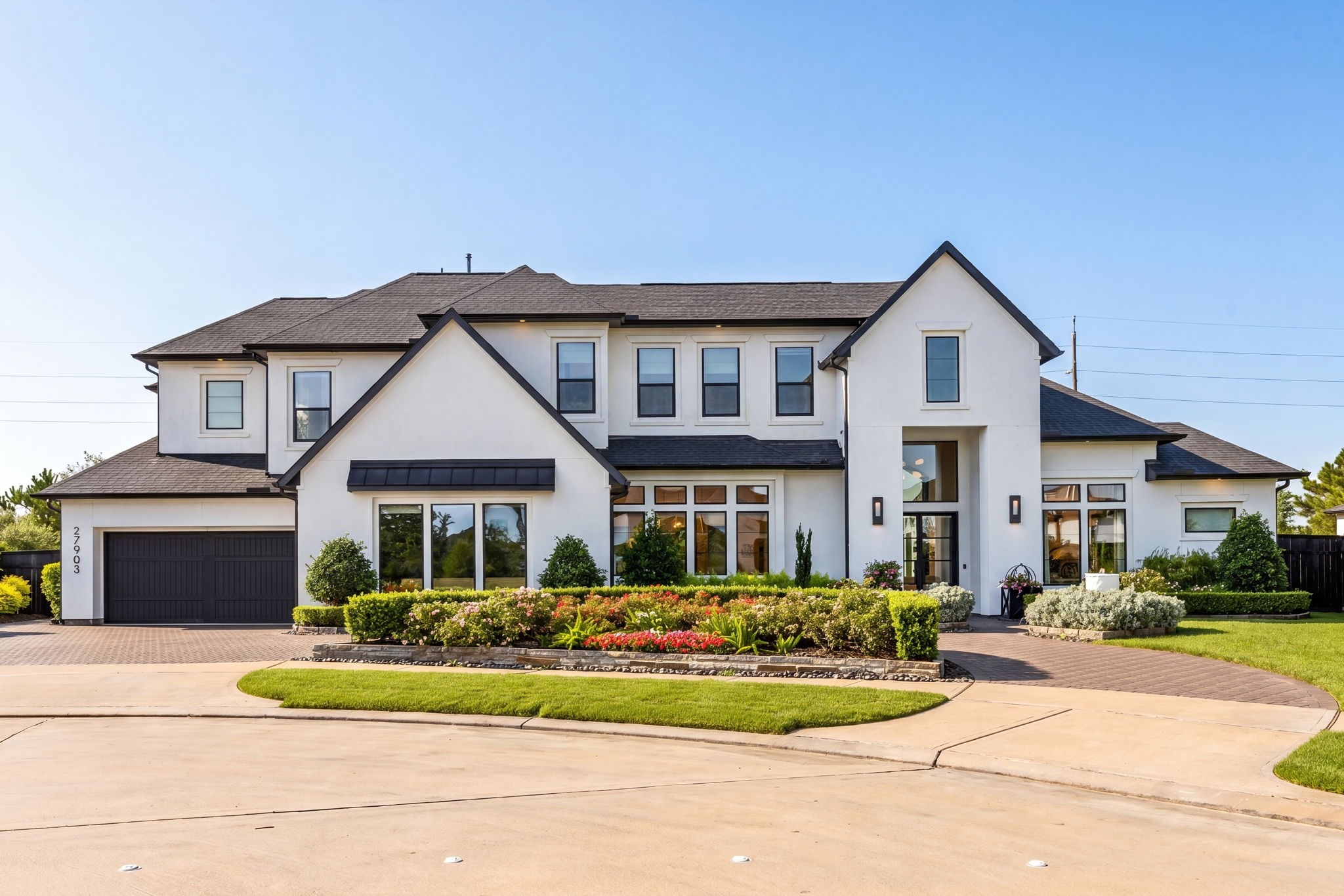 27903 Indigo Ridge Drive Fulshear, TX 77441 - Photo 1 of 50 Modern custom home with clean architectural lines, lush landscaping, and exceptional curb appeal.