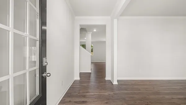 a view of a hallway with wooden floor