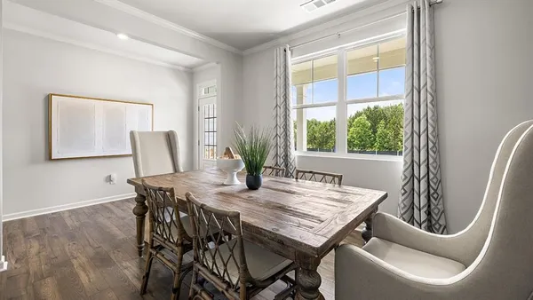 a view of a dining room with furniture and window