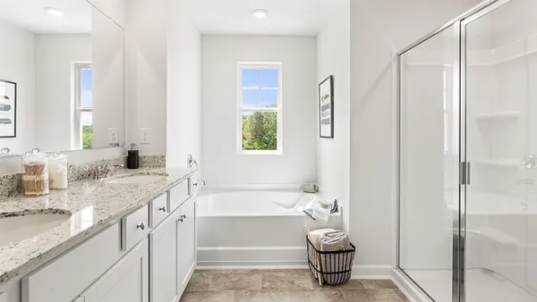 a bathroom with a tub sink and a mirror