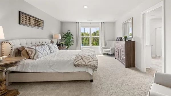 a spacious bedroom with a bed and a couch