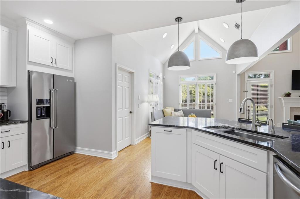 5249 Magnolia Walk Circle Atlanta, GA 30338 - Photo 11 of 30 a open kitchen with stainless steel appliances granite countertop a sink a refrigerator and a stove