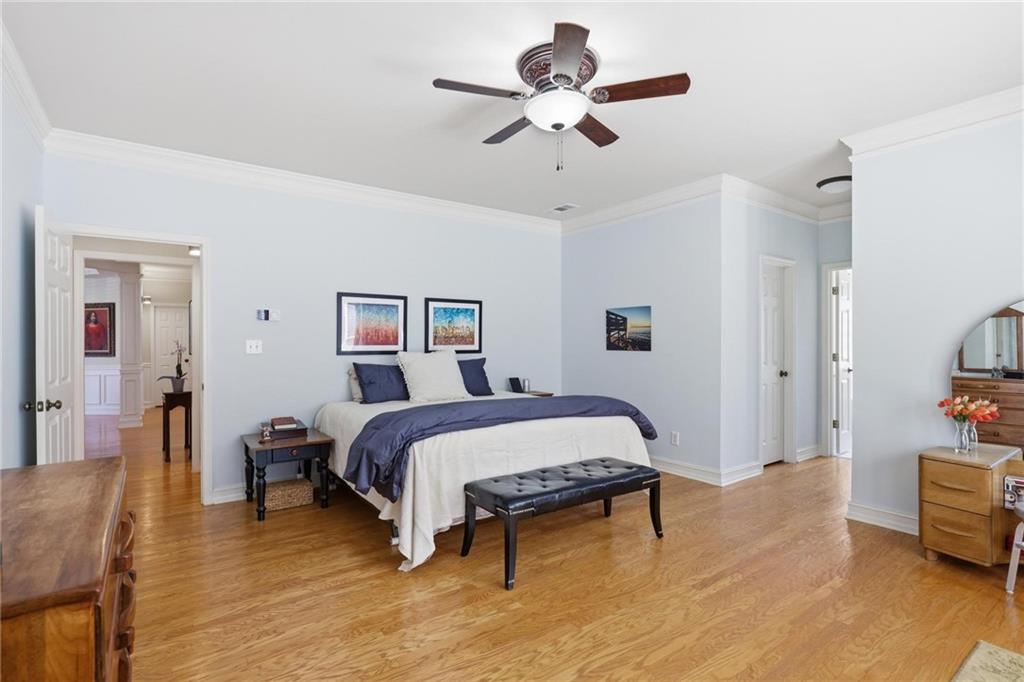 5249 Magnolia Walk Circle Atlanta, GA 30338 - Photo 13 of 30 a spacious bedroom with a bed and a chandelier