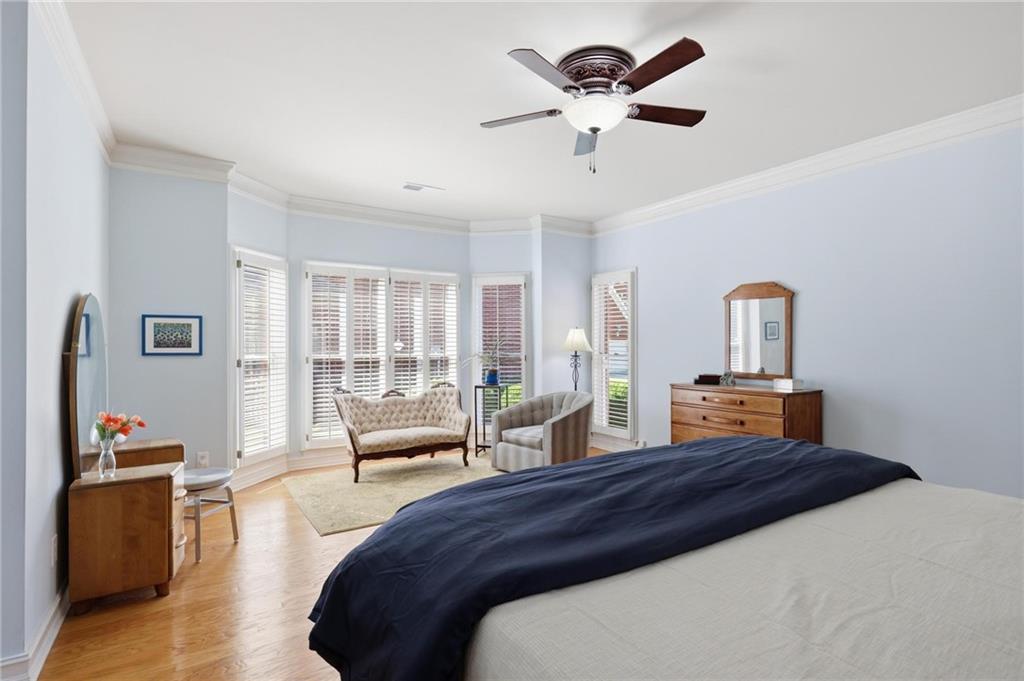 5249 Magnolia Walk Circle Atlanta, GA 30338 - Photo 14 of 30 a bedroom with a bed a ceiling fan and a large window