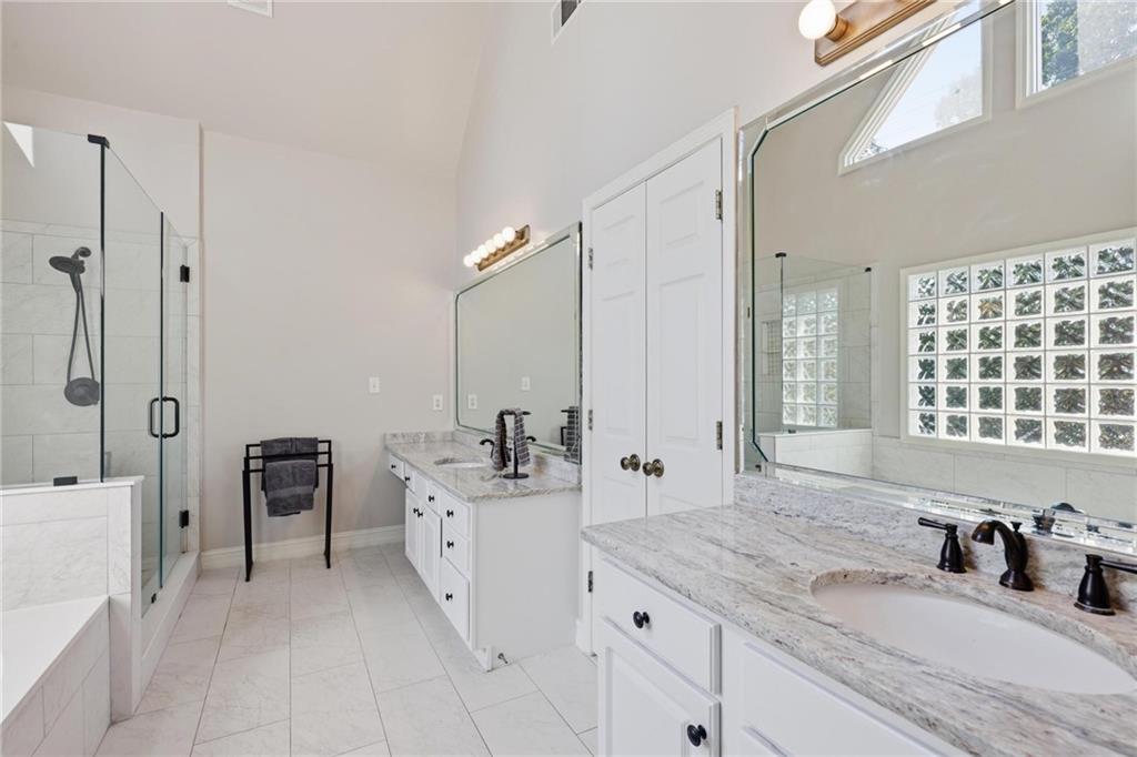 5249 Magnolia Walk Circle Atlanta, GA 30338 - Photo 16 of 30 a bathroom with a sink double vanity granite tub shower and a mirror