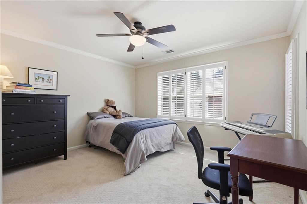 5249 Magnolia Walk Circle Atlanta, GA 30338 - Photo 22 of 30 a bed room with a bed and a desk