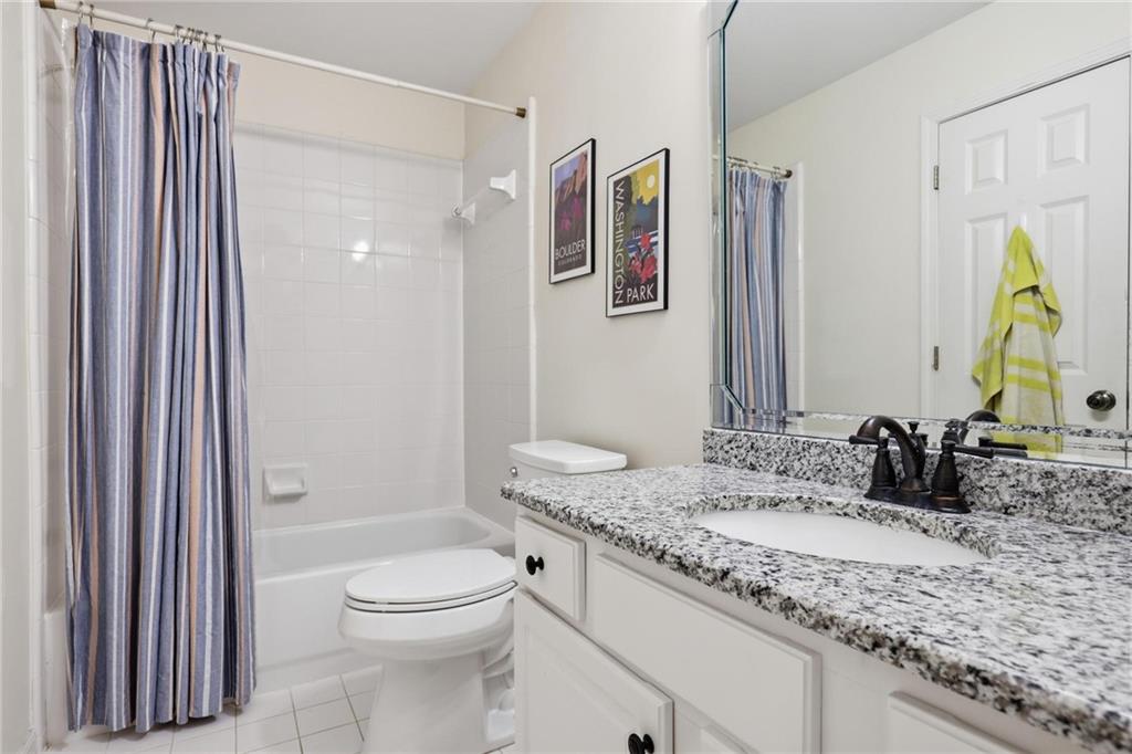 5249 Magnolia Walk Circle Atlanta, GA 30338 - Photo 23 of 30 a bathroom with a granite countertop sink a toilet and shower