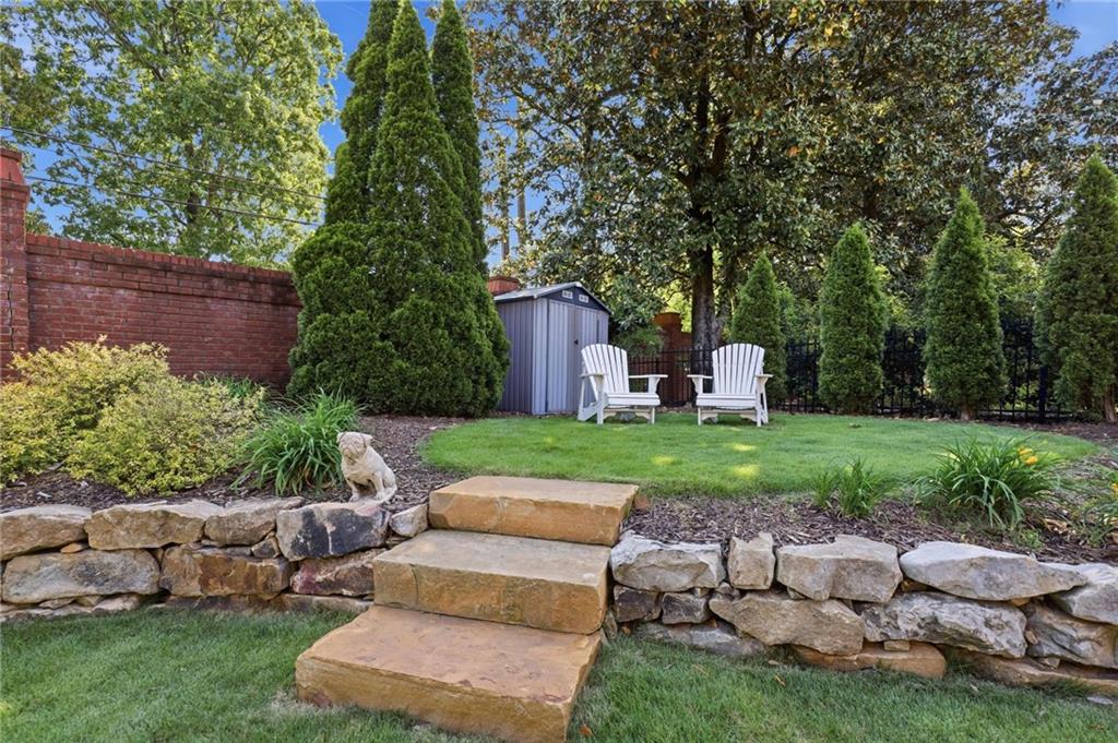 5249 Magnolia Walk Circle Atlanta, GA 30338 - Photo 27 of 30 a view of a house with backyard sitting area and garden