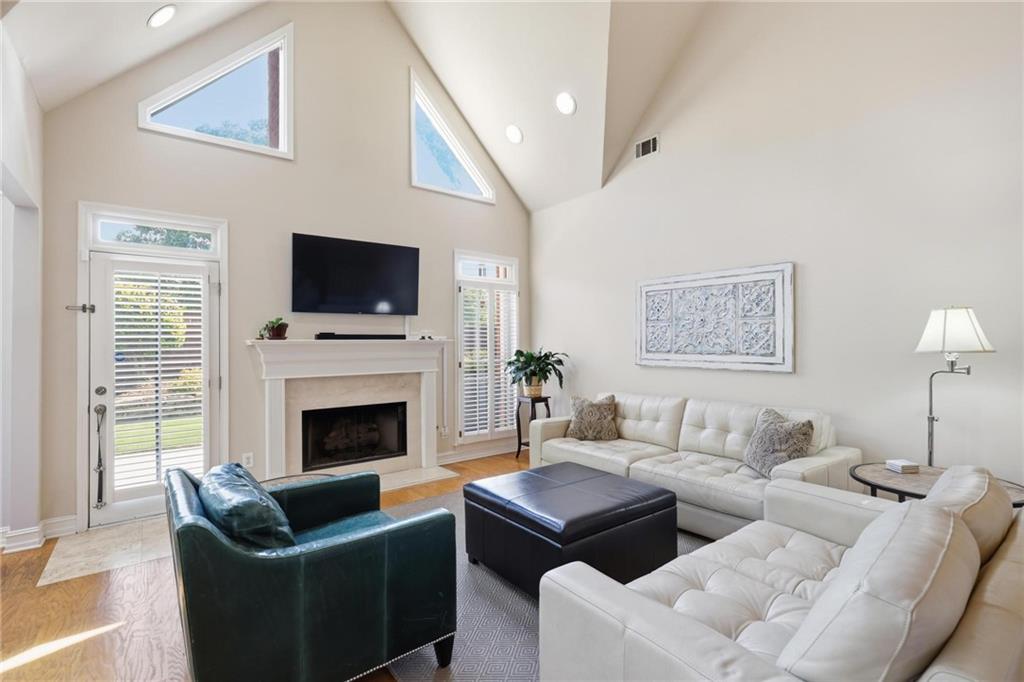 5249 Magnolia Walk Circle Atlanta, GA 30338 - Photo 3 of 30 a living room with furniture a flat screen tv and a fireplace