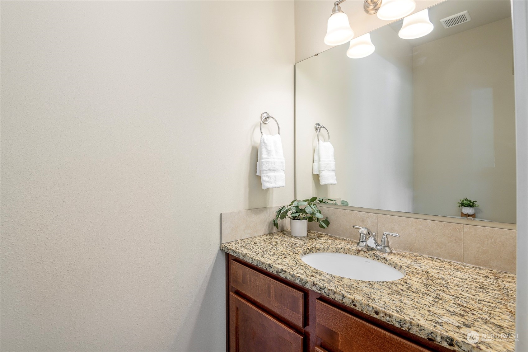 14453 98th Way Southeast Yelm, WA 98597 - Photo 11 of 23 a bathroom with a granite countertop sink and a mirror