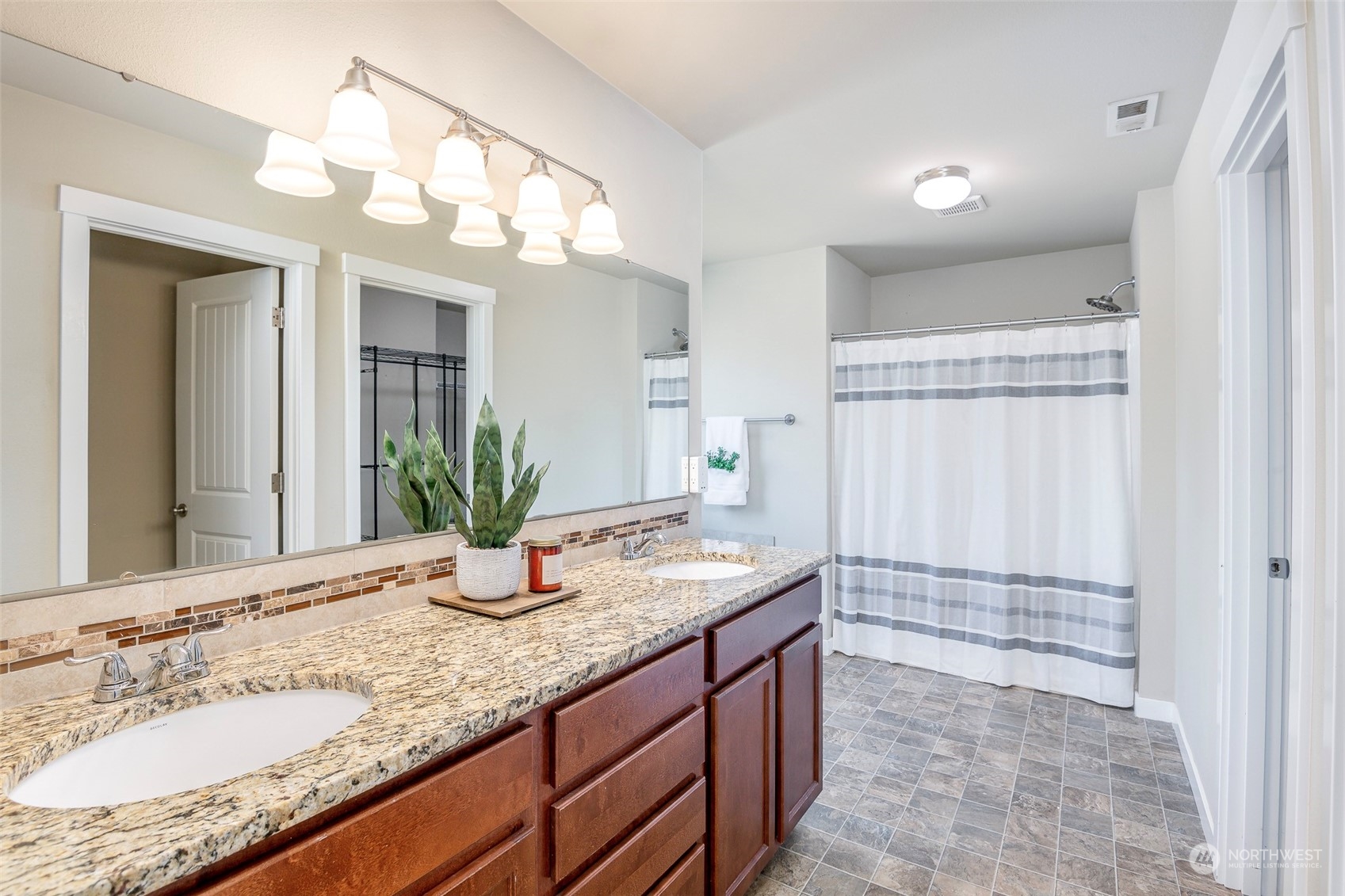 14453 98th Way Southeast Yelm, WA 98597 - Photo 13 of 23 a bathroom with a granite countertop sink and a mirror