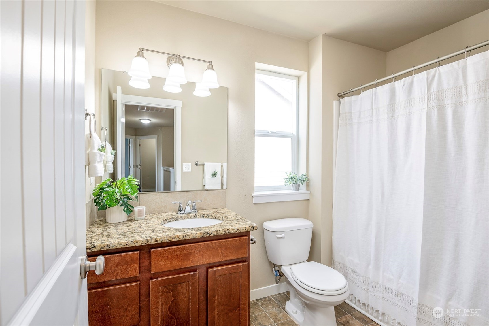 14453 98th Way Southeast Yelm, WA 98597 - Photo 17 of 23 a bathroom with a granite countertop sink a toilet and a mirror