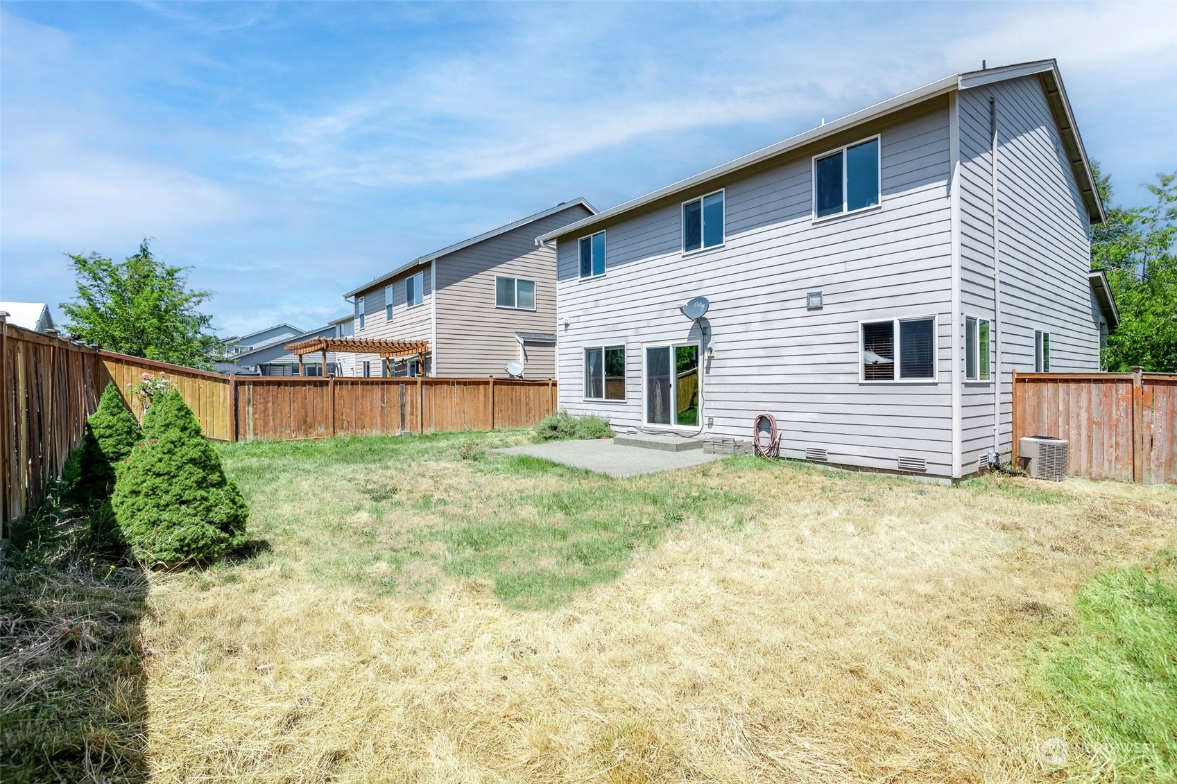 14453 98th Way Southeast Yelm, WA 98597 - Photo 21 of 23 a backyard of a house with plants and wooden fence