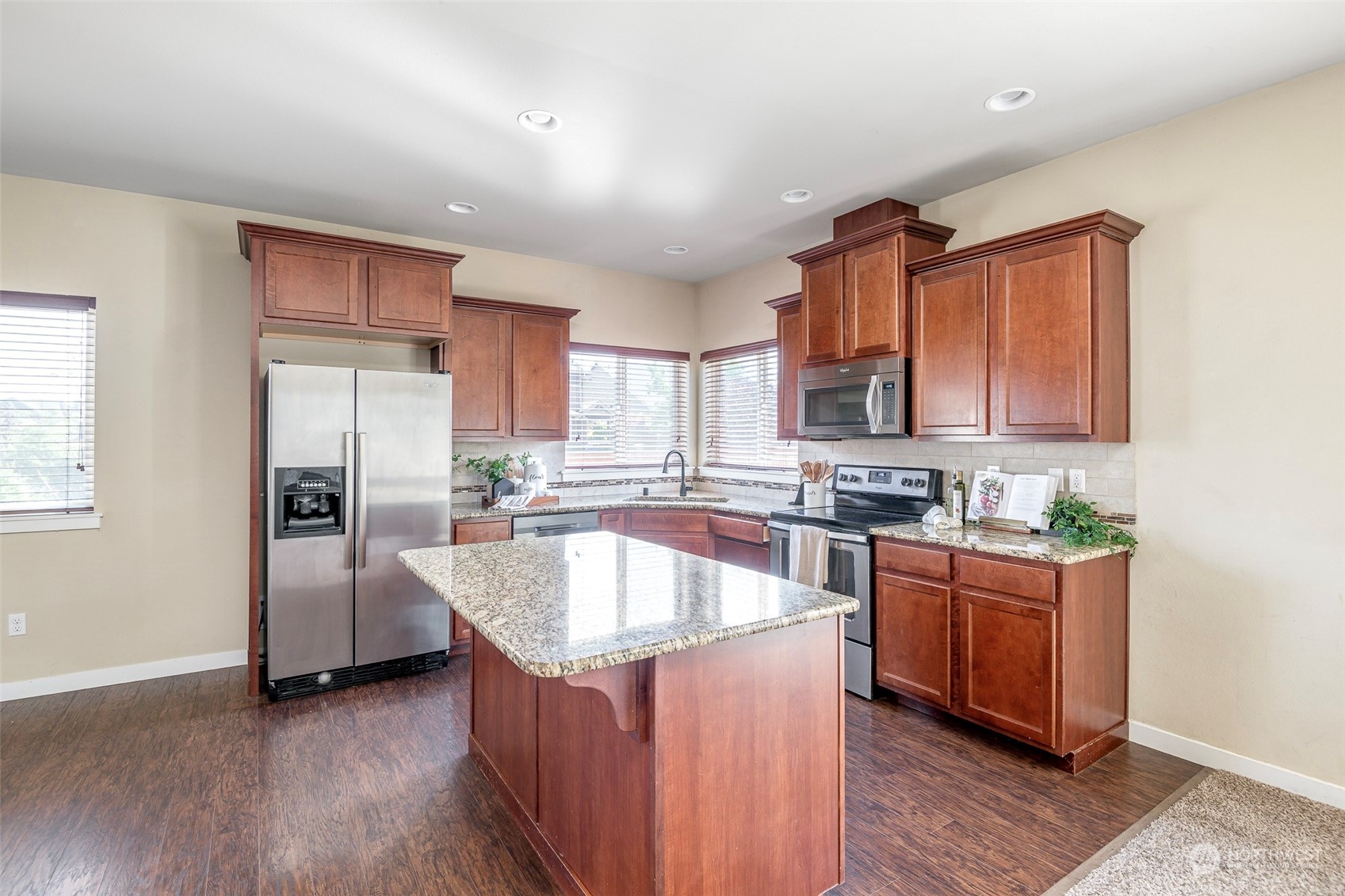 14453 98th Way Southeast Yelm, WA 98597 - Photo 6 of 23 a kitchen with stainless steel appliances granite countertop a stove a sink and a refrigerator