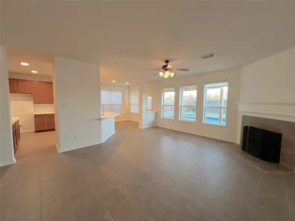 a view of a livingroom with a fireplace and window