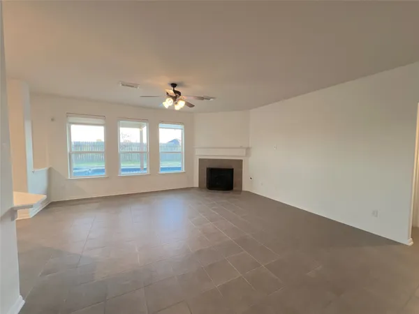 wooden floor in an empty room with a fireplace