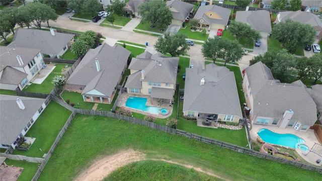 an aerial view of residential houses with outdoor space and street view